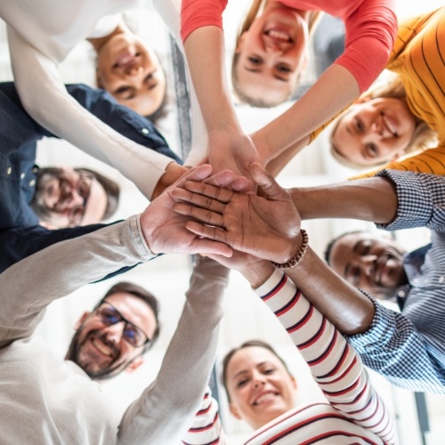 group of people with their hands in