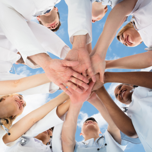 group with hands in a circle