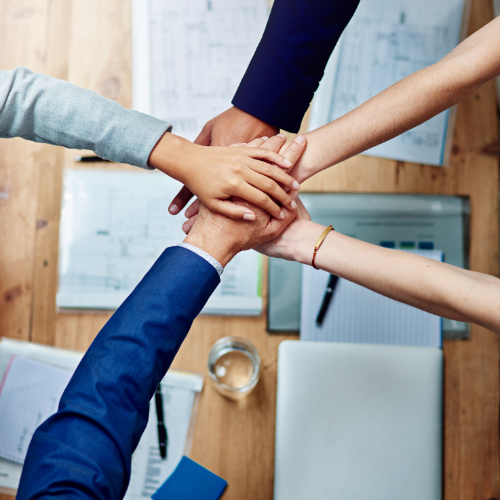 business people with hands in a circle