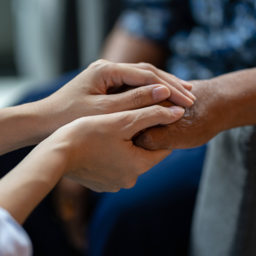 people holding hands comforting each other