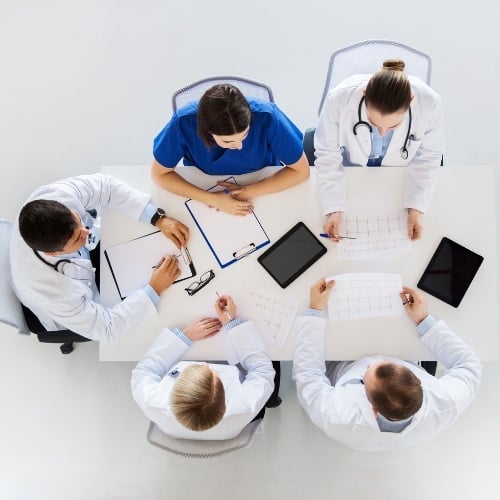 group of doctors sitting around a table