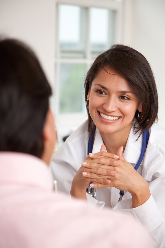 Doctor listening to a patient at her practice