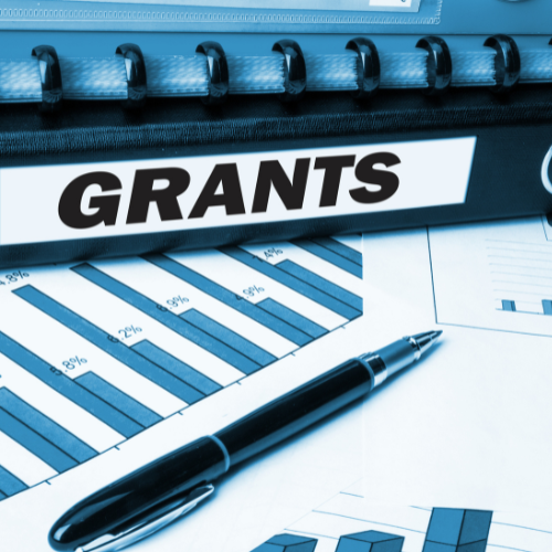 grant binder with charts and graphs and a pen