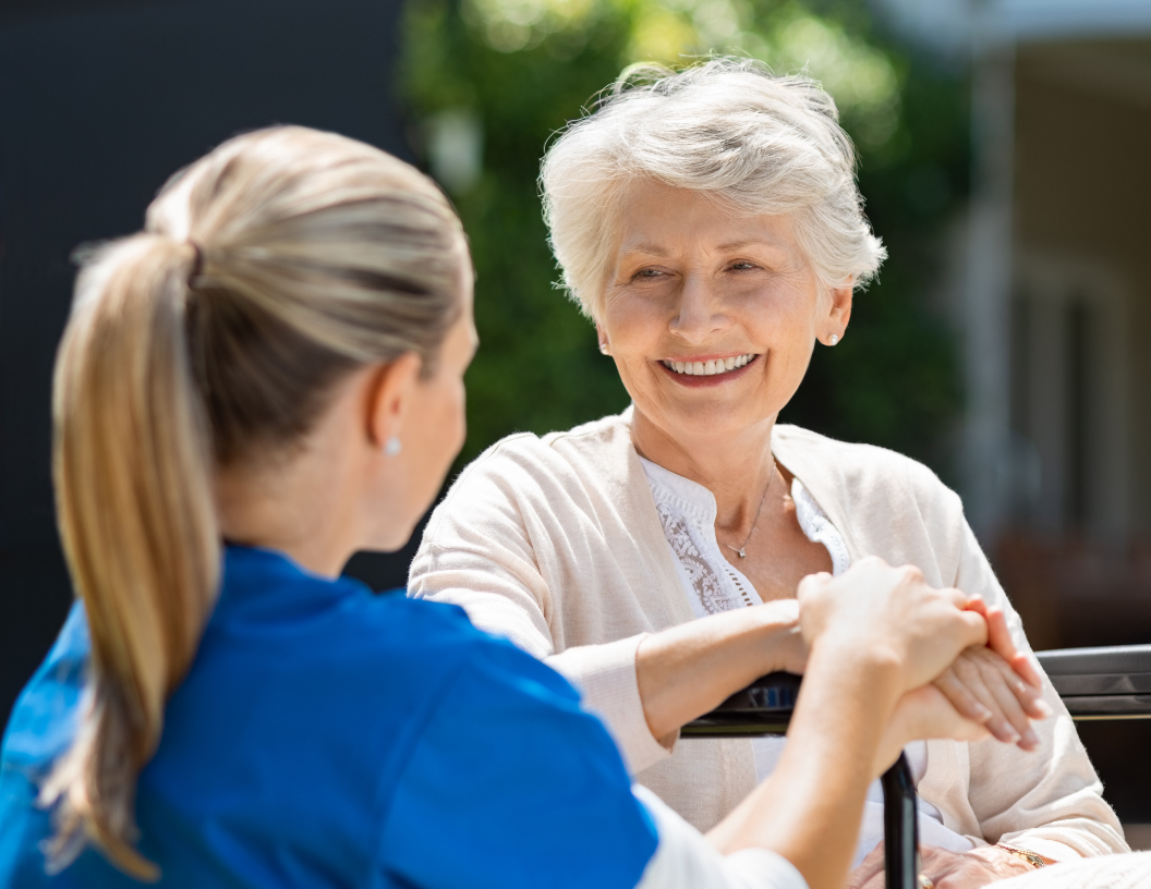 patient smiling with nurse outside