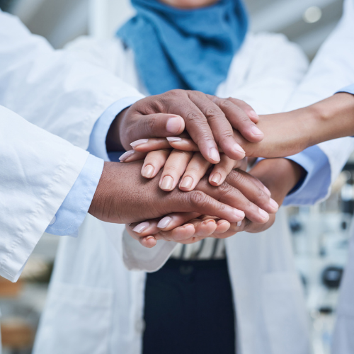 doctor's hands stacked on top of each other